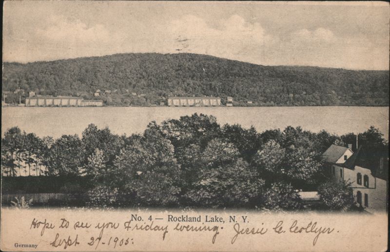 Rockland Lake with Forested Hill and Shoreline Buildings New York