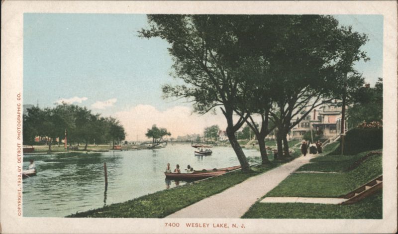Wesley Lake with Boaters and Tree-Lined Walkway Asbury Park New Jersey