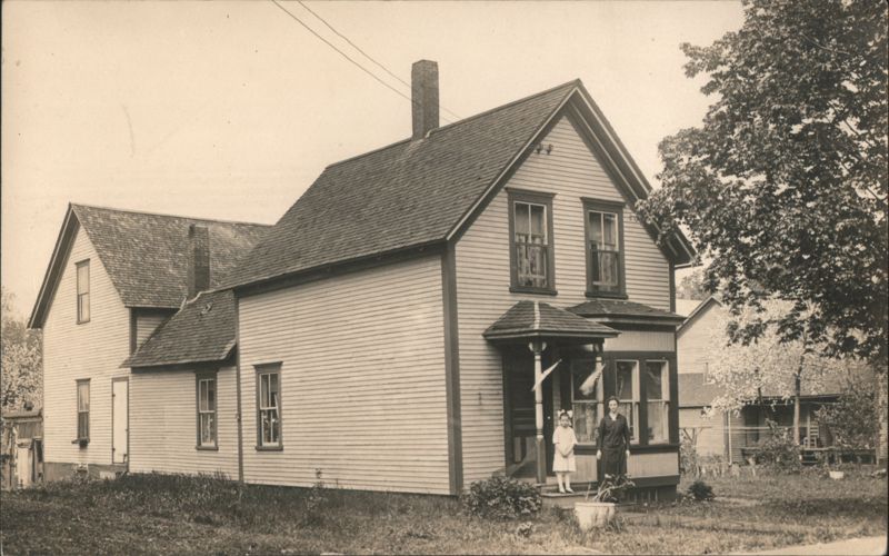 Two-Story House with Porch and Two People Family Portaits