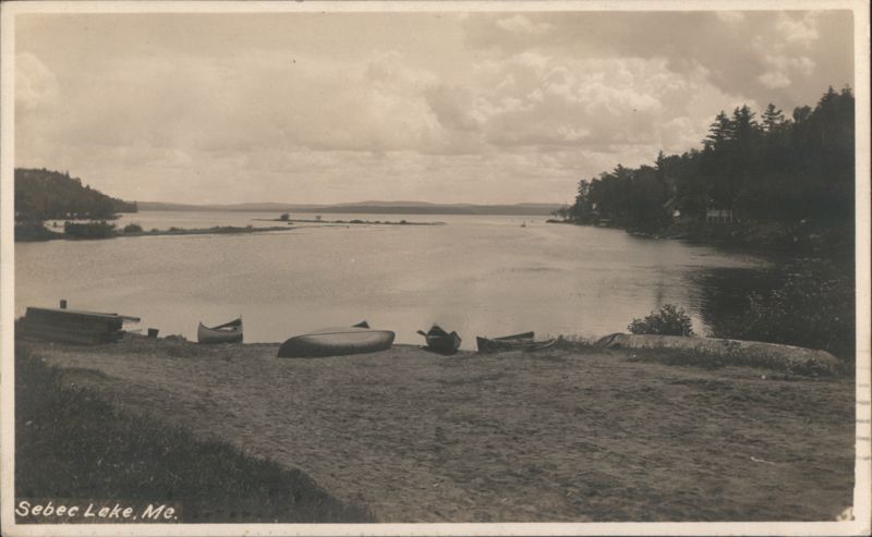 Canoes on the Sandy Shore of Sebec Lake Maine