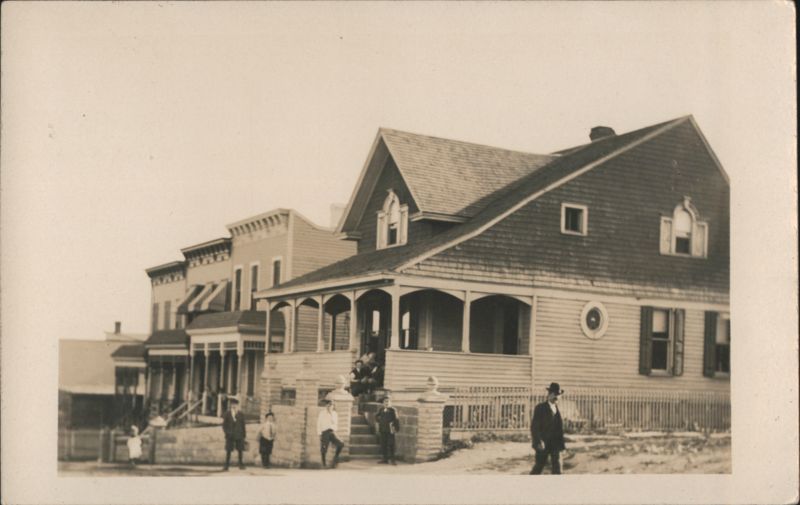 Group of children and a man standing in front of houses