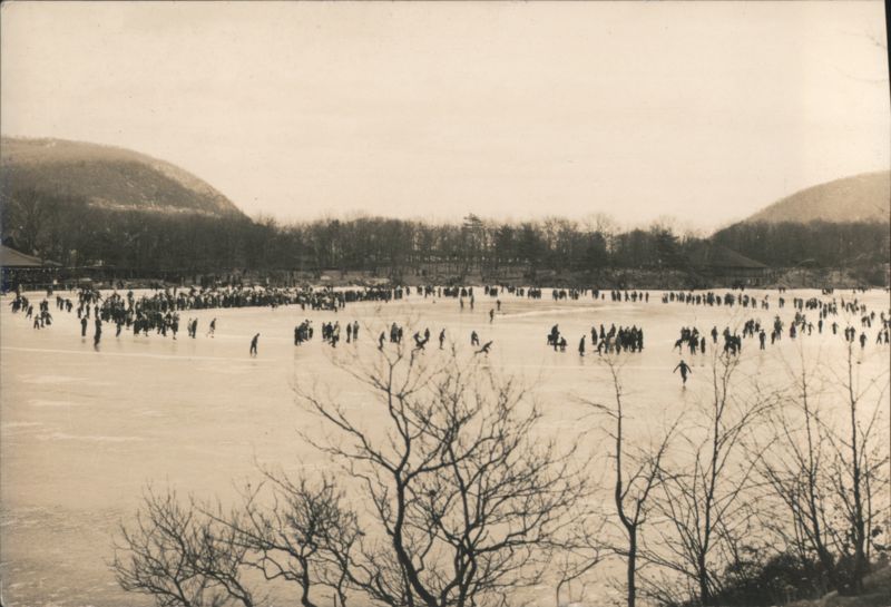 People Ice Skating on Frozen Lake