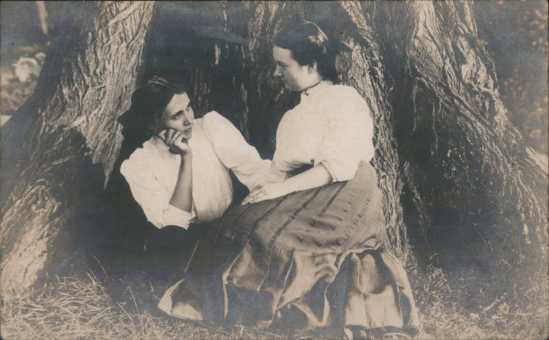 Two Women Sitting Together by a Large Tree