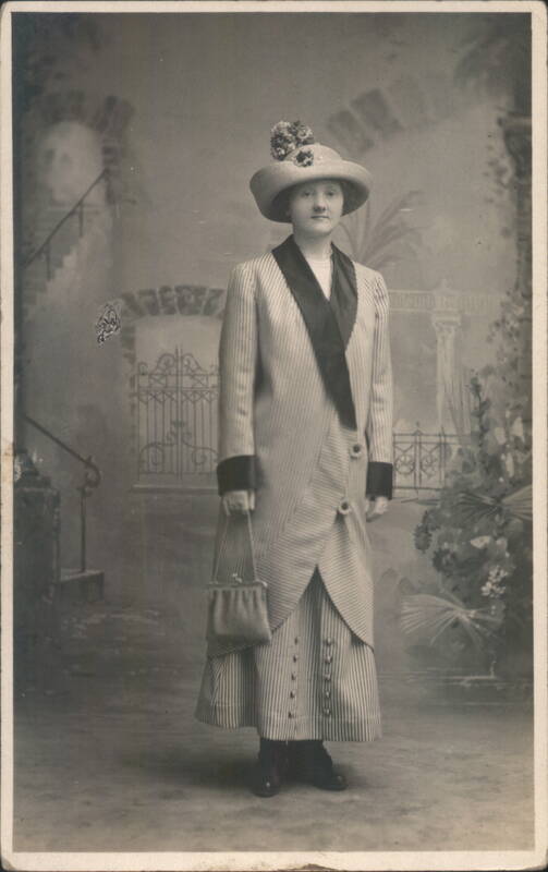 Woman in Striped Coat and Hat with Purse Women
