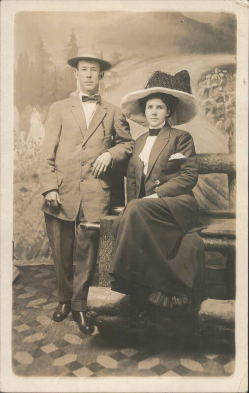 Man in Fedora and Woman in Large Hat Portrait Couples