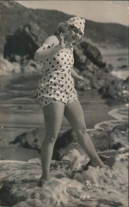 Woman in Polka Dot Swimsuit and Cap at the Beach Swimsuits & Pinup