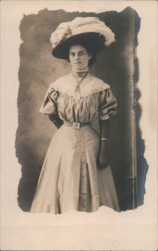 Woman Wearing Hat with Feathers and Swastika Belt Buckle