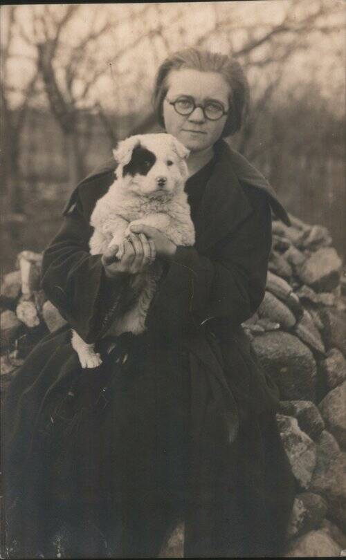 Woman Holding White Puppy w/Black Eye Patch Women