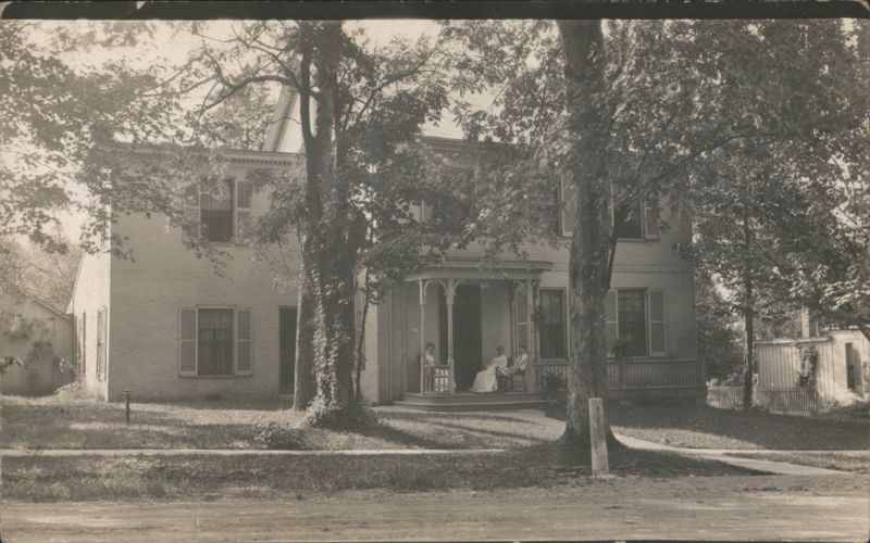 Two-Story Brick House with Porch and Three People Buildings