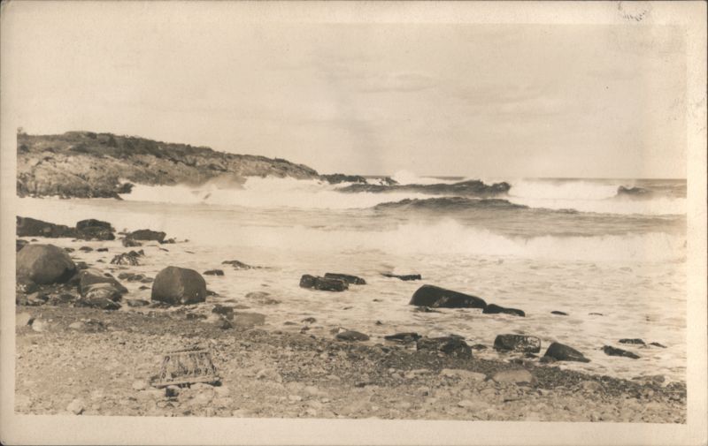 Ocean waves crashing on rocky shore with lobster trap