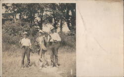 Three Men Standing in a Field with Bottles Postcard