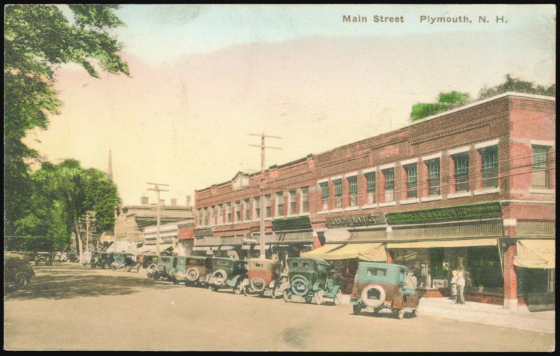 Main Street Scene with Rand's Market and J.W. Harrower Plymouth New Hampshire