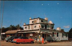 Parsons Indian Trading Post with Totem Pole and Cars Postcard