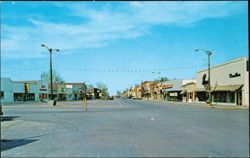 Main Street Looking Down Business District on Hiway #2 Postcard