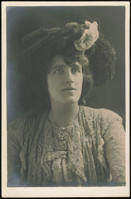Julia Neilson in Large Floral Hat and Lace Gown