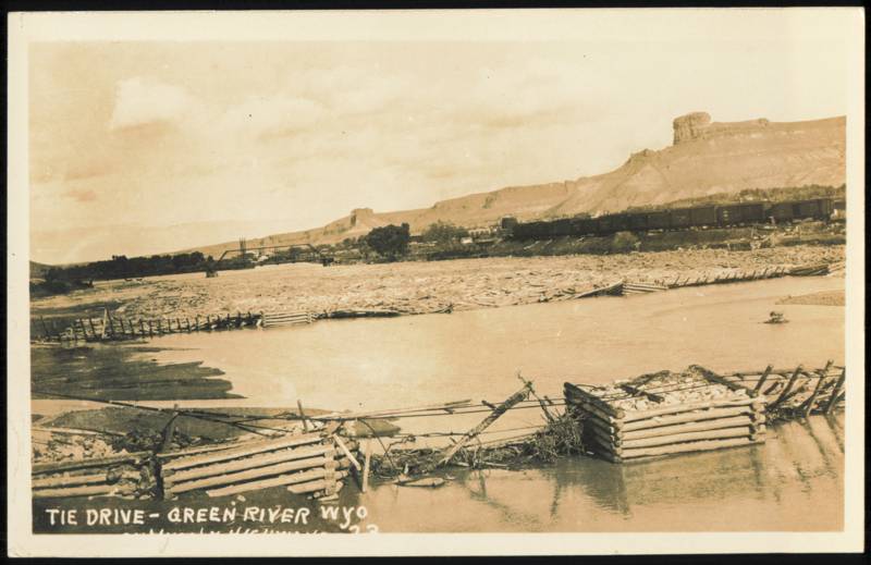 Railroad Tie Drive on Green River with Train and Cliffs Wyoming