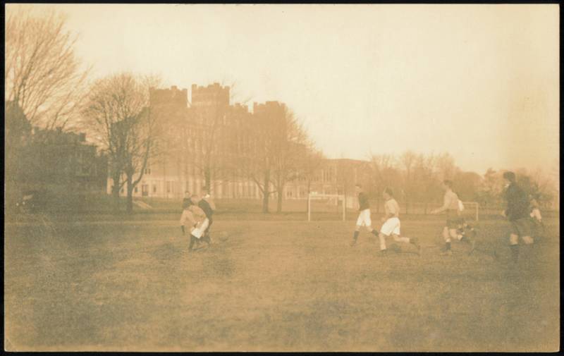 Men Playing Soccer on Field with Castle-like Building Roxbury New York