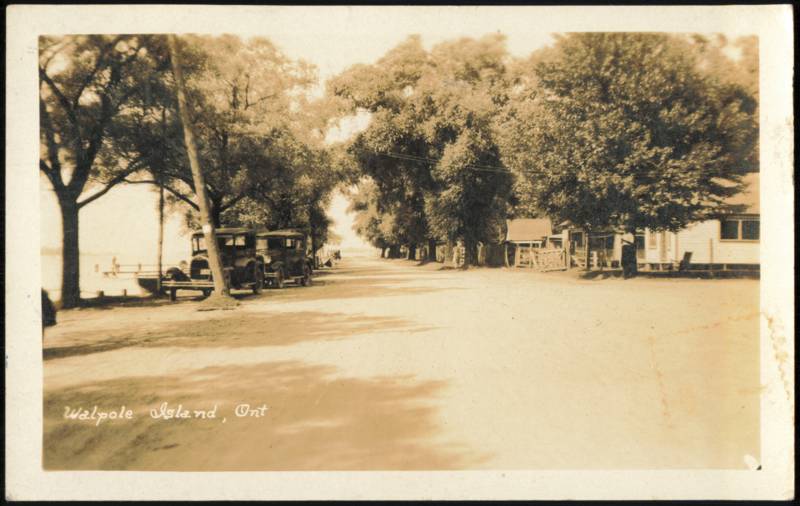 Tree-Lined Waterfront Road with Vintage Automobiles Walpole Island Canada