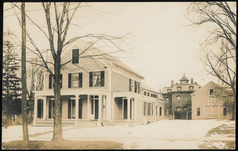 Large Two-Story House with Porch and Barn in Winter