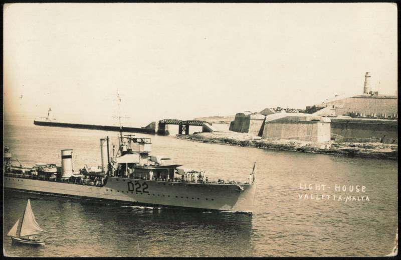 Lighthouse and Naval Destroyer D22 in Grand Harbour Valletta Malta
