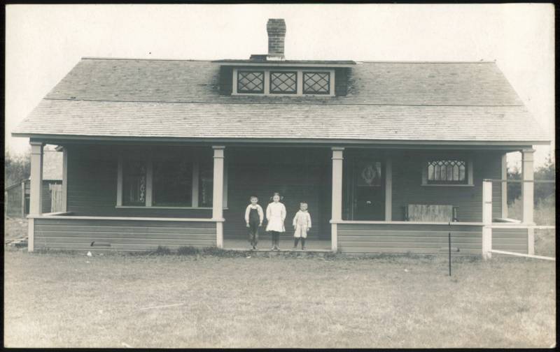 Three Children Standing on Porch of Craftsman Bungalow Washington