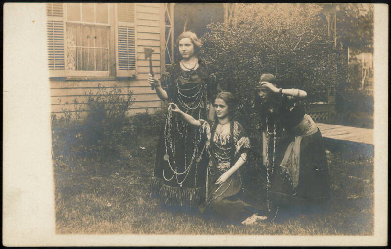 Three Young Women in Native American Costumes with Prop Axe