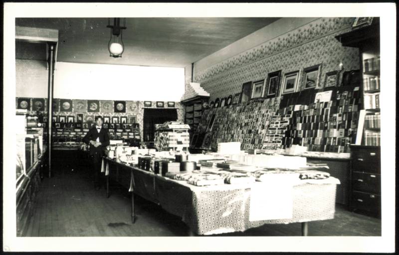 Stationery Store Interior with Postcard Display & Clerk