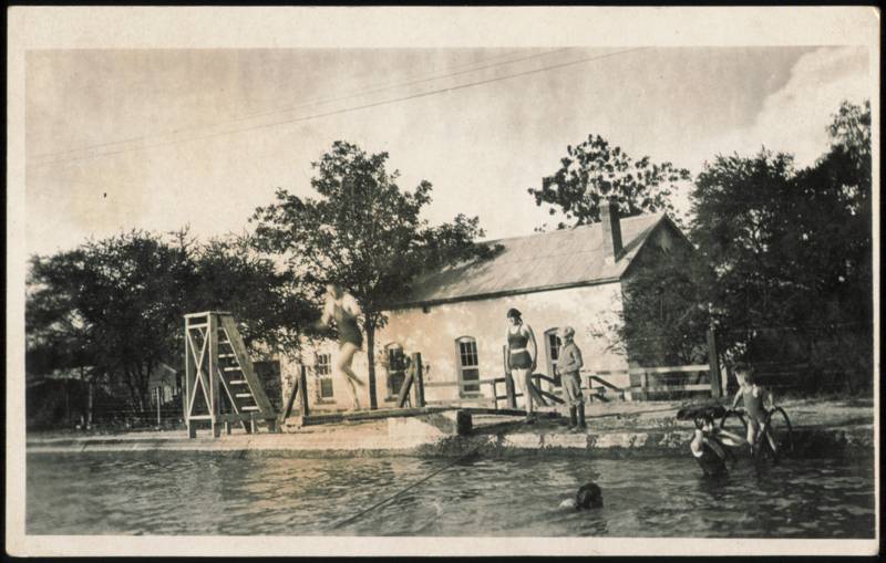 People Swimming and Diving at a Pool Buildings