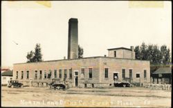 North Land Dairy Co. Building with Trucks and Milk Cans Postcard