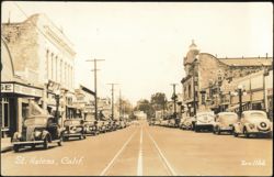 Downtown Main Street Scene with Vintage Cars & Shops Postcard