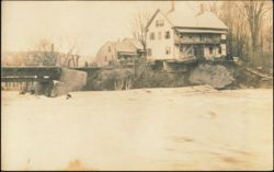 Flood Waters Eroding Riverbank Near Bridge and Houses Postcard