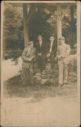 Four Young Men in Suits at Rustic Stone Gazebo Postcard