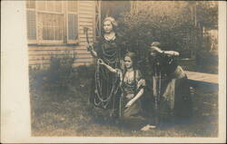 Three Young Women in Native American Costumes with Prop Axe Postcard