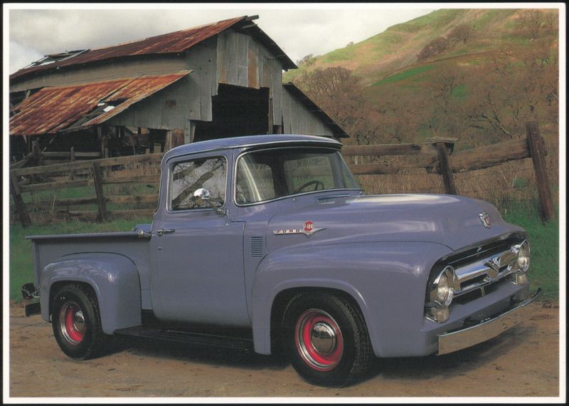 Blue Ford F-100 Pickup Truck by a Rustic Barn