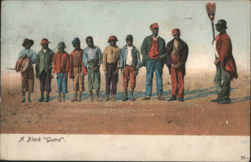 A Black Guard Lineup of Boys with Drum and Broom