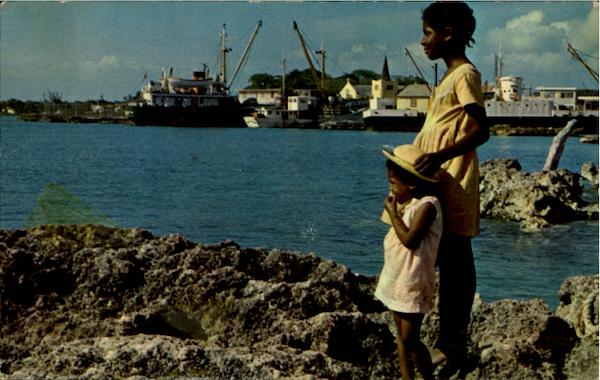 Caymanian Youngsters Gaze Out To Sea At Georgetown Harbour Cayman Islands