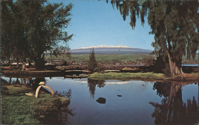 Mauna Kea mirrored in a pond with bridge, Hilo Hawaii