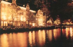 Hotel Estherea and Canal Illuminated at Night, Amsterdam Postcard