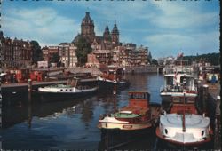 Boats in Amsterdam Canal with Historic Buildings Postcard