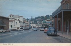 Main Street View with Cars & Historic Buildings Postcard