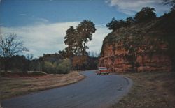 Red Rock State Park Road with Red Car Postcard