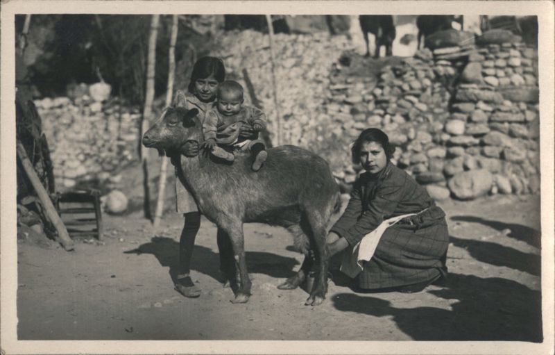Child on Goat with Two Women, Rural Scene