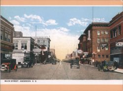 Main Street, Aberdeen, SD with Cars and Businesses Postcard