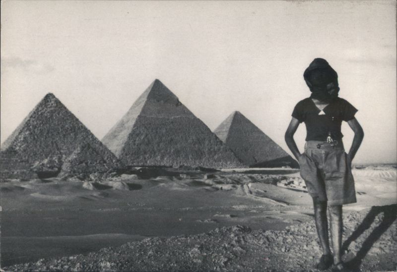 Pyramids in Desert Landscape, Figure with Covered Head