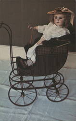 French Bisque Doll in Carriage, Burrows Toy Museum Postcard