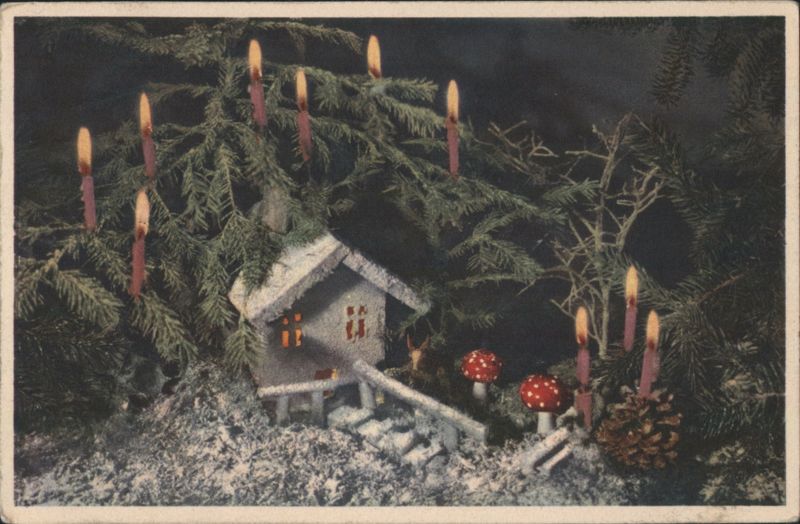 Christmas Scene with Miniature House, Lit Candles, and Evergreen Decor