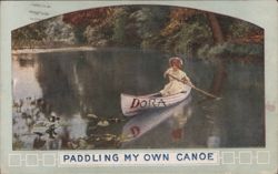 Girl Paddling Canoe with 'DORA' on Side, 'Paddling My Own Canoe' Text Postcard