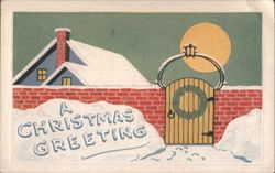 A Christmas Greeting: Snow-Covered House, Wreath, & Gate in Winter Scene Postcard