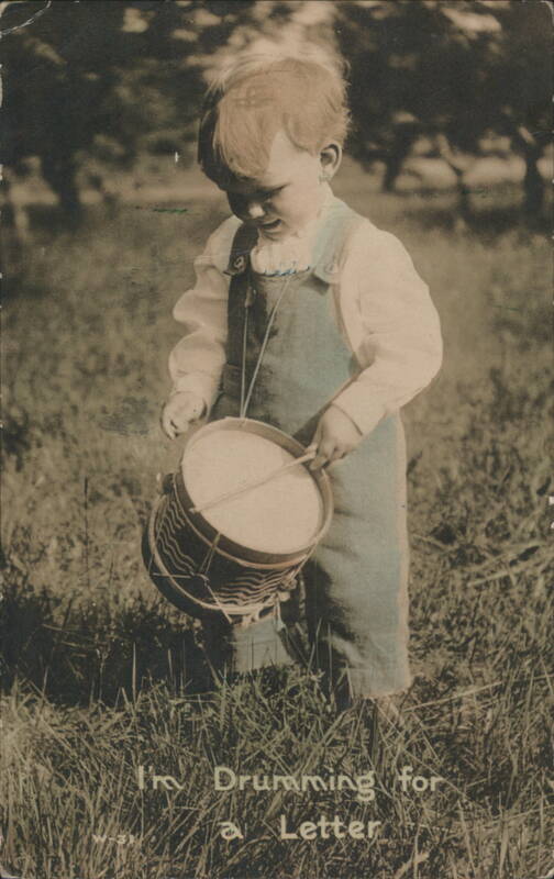 Toddler Playing Drum 'I'm Drumming for a Letter' in Grassy Field