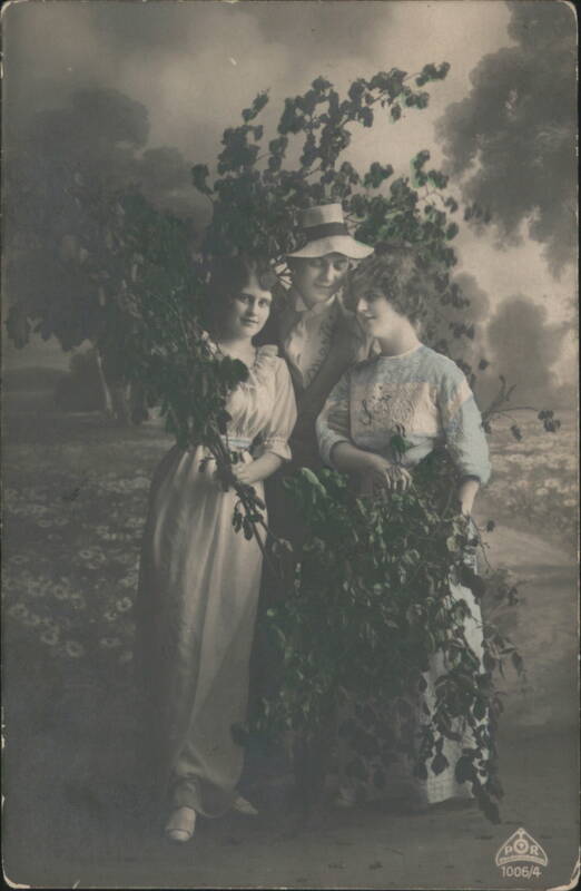 Two Women and Man in Staged Garden Portrait with Lush Greenery